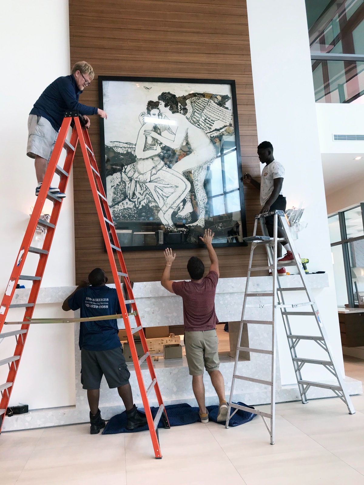 Catalyst Art team installing a large artwork on site