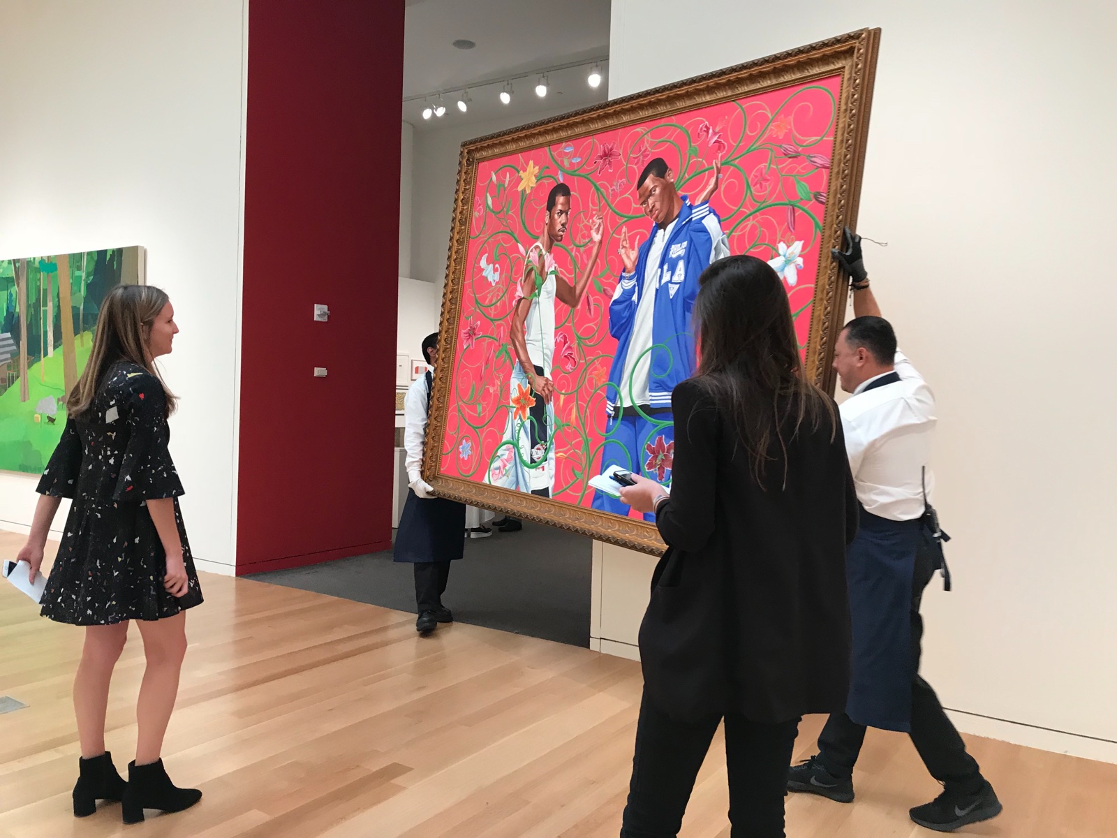 Large-scale artwork being handled in a gallery setting